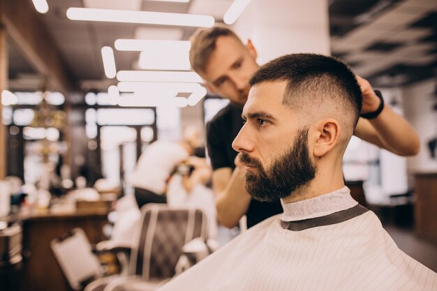 man-barbershop-salon-doing-haircut-beard-trim_1303-20936